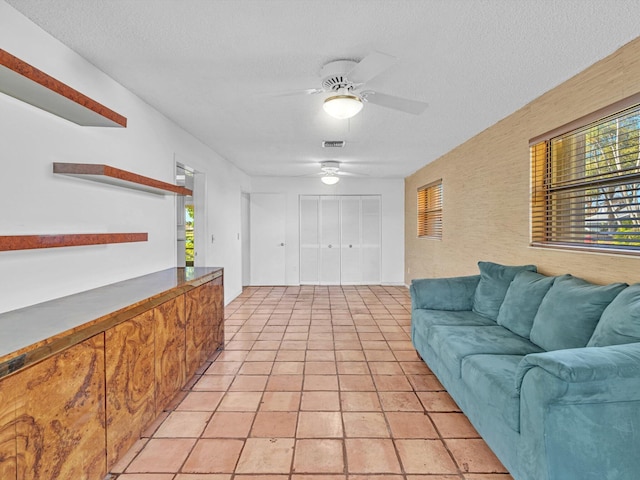 living room with light tile patterned floors and a textured ceiling