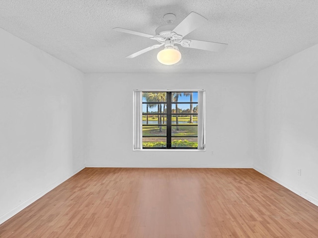 empty room featuring a textured ceiling, light hardwood / wood-style floors, and ceiling fan