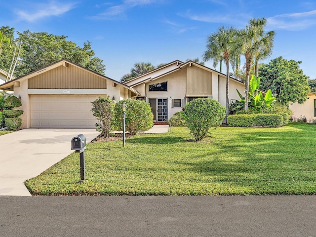 single story home featuring a front lawn and a garage