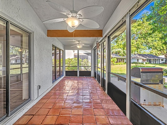 unfurnished sunroom with a wealth of natural light and ceiling fan