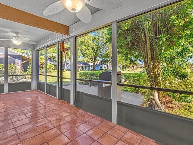 unfurnished sunroom featuring ceiling fan