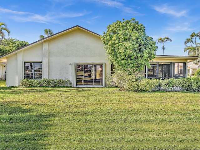 rear view of property with a lawn