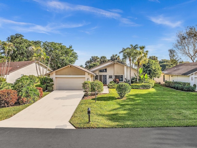 single story home featuring a garage and a front lawn