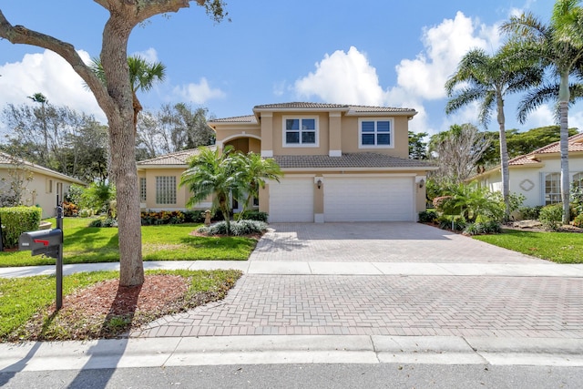 mediterranean / spanish home featuring a front lawn and a garage