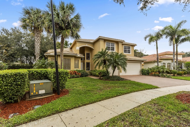6966 Great Falls Cir, Boynton Beach, FL 33437 - mediterranean / spanish house with decorative driveway, stucco siding, a front yard, a garage, and a tiled roof