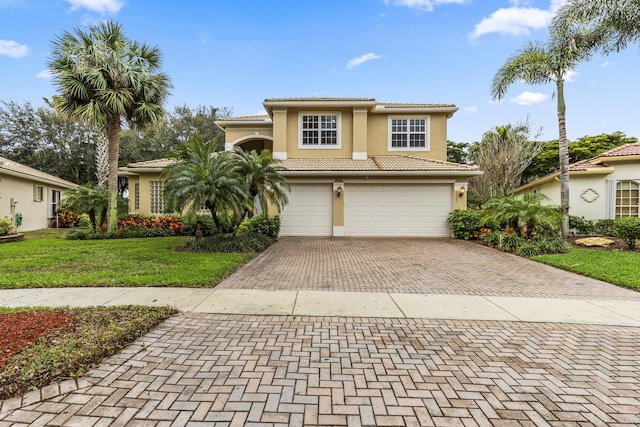 mediterranean / spanish-style house with a garage and a front yard