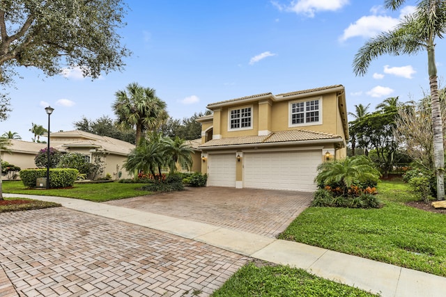 view of front of house featuring a garage and a front lawn