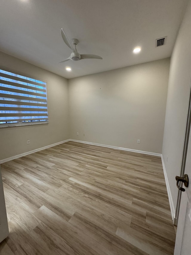 empty room featuring ceiling fan and light hardwood / wood-style floors