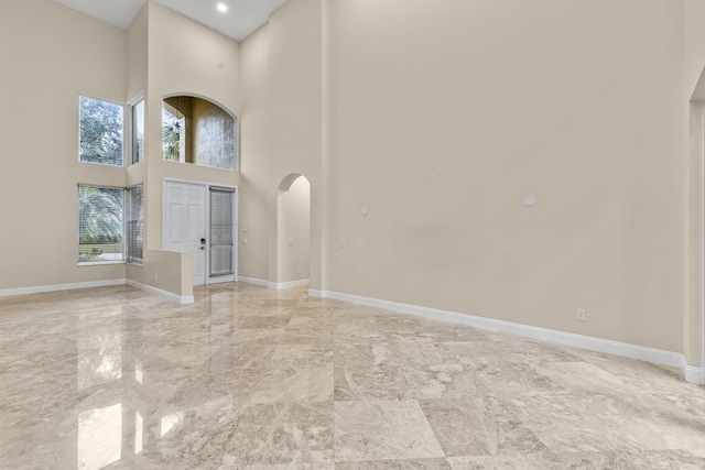 entryway featuring a towering ceiling