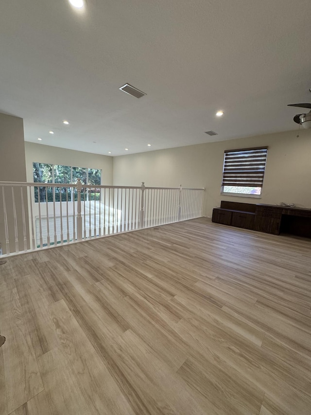 spare room with light hardwood / wood-style floors and ceiling fan