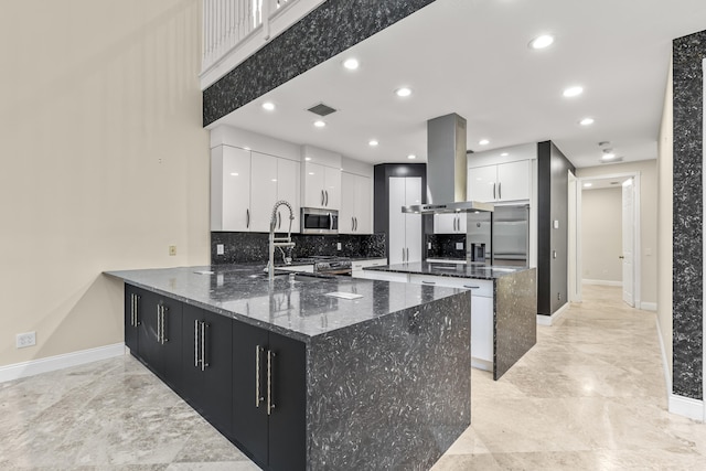 kitchen with white cabinetry, backsplash, dark stone countertops, a center island, and island exhaust hood