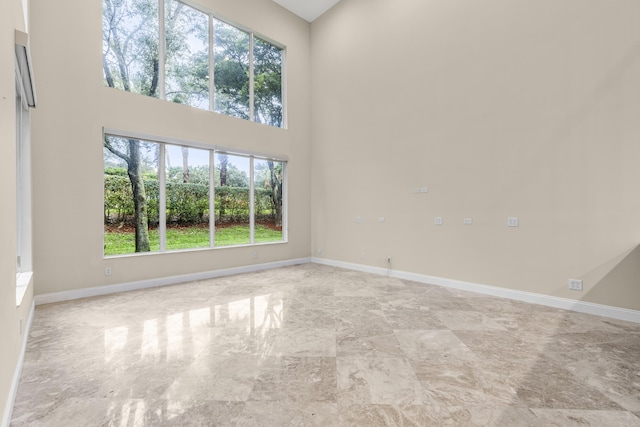 spare room with a towering ceiling