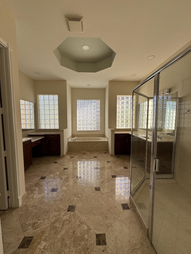 bathroom with vanity, plus walk in shower, and a tray ceiling