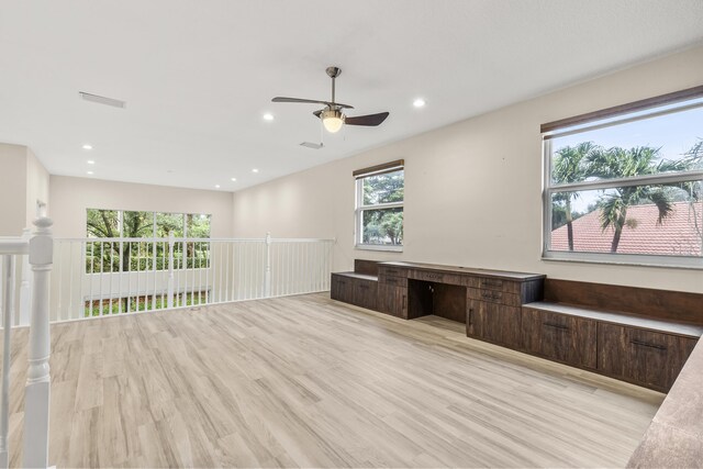 interior space with a raised ceiling and ceiling fan