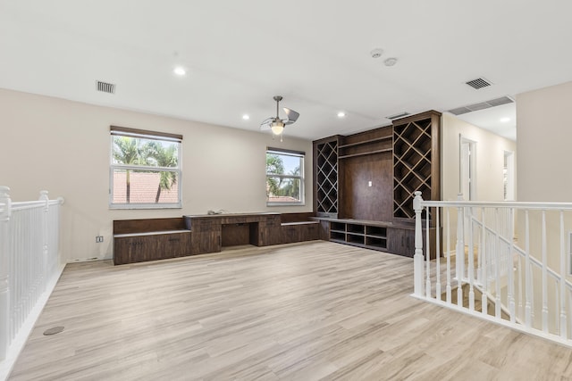 spare room featuring plenty of natural light and light hardwood / wood-style floors