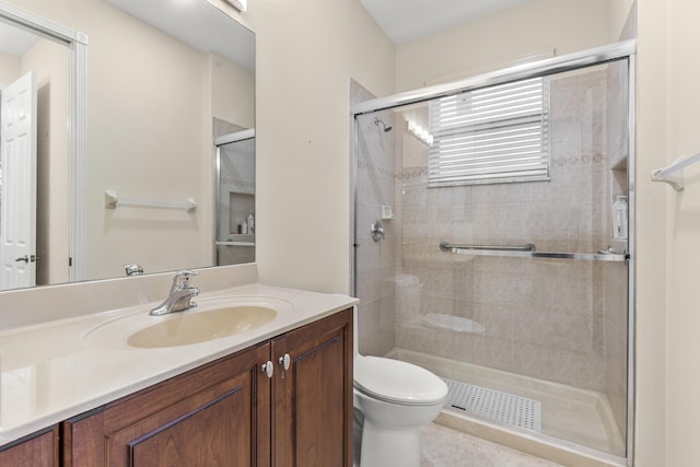 bathroom with vanity, an enclosed shower, and toilet