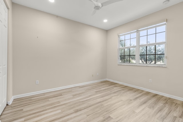 empty room with light hardwood / wood-style floors and ceiling fan