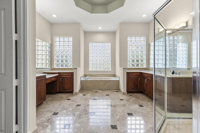 bathroom featuring vanity and shower with separate bathtub