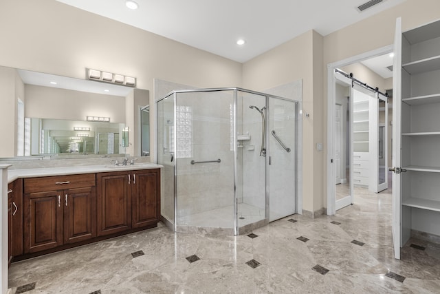 bathroom featuring vanity and a shower with shower door