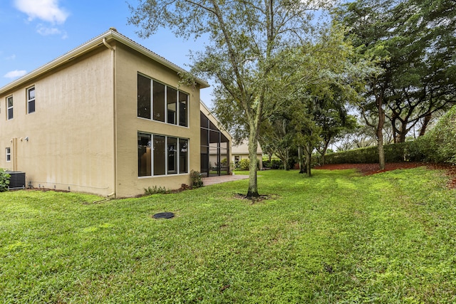 rear view of house featuring a yard and cooling unit