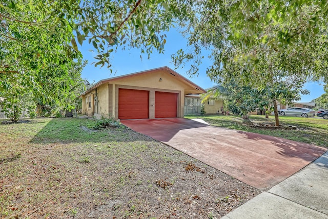 ranch-style home with a garage and a front lawn