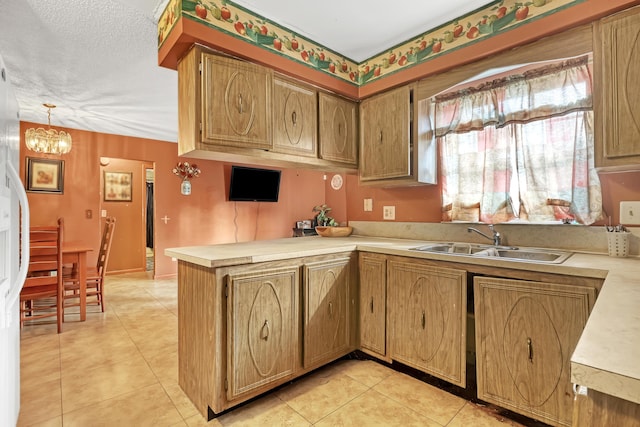 kitchen featuring kitchen peninsula, sink, light tile patterned floors, decorative light fixtures, and a notable chandelier