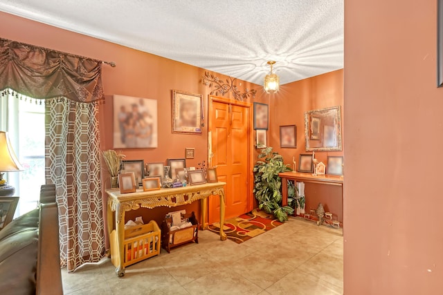 interior space with a textured ceiling and tile patterned floors