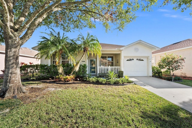 ranch-style home with a front lawn, covered porch, and a garage