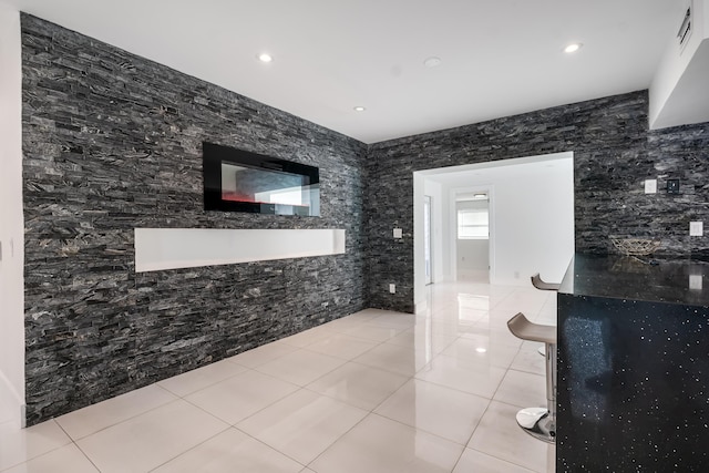 bathroom with tile patterned floors and tile walls