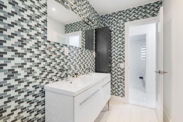 bathroom with tile patterned flooring, vanity, and tile walls