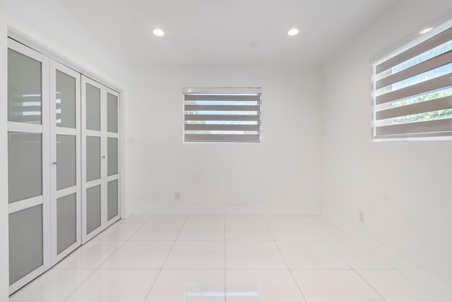 spare room featuring light tile patterned floors