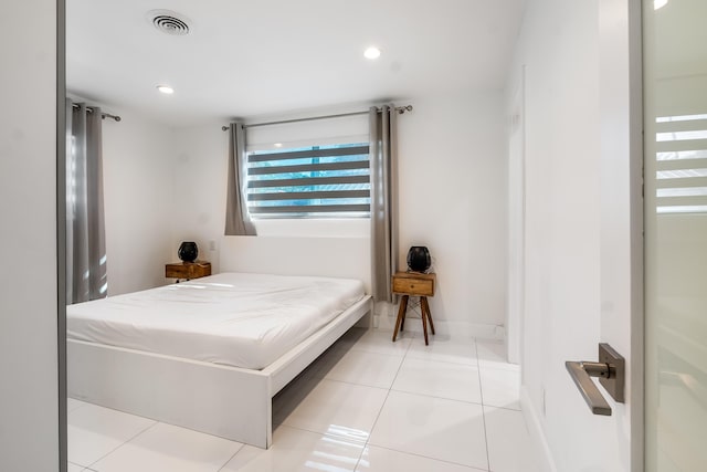 bedroom with light tile patterned floors