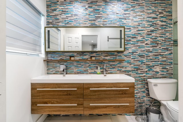 bathroom with decorative backsplash, tile patterned flooring, vanity, and toilet