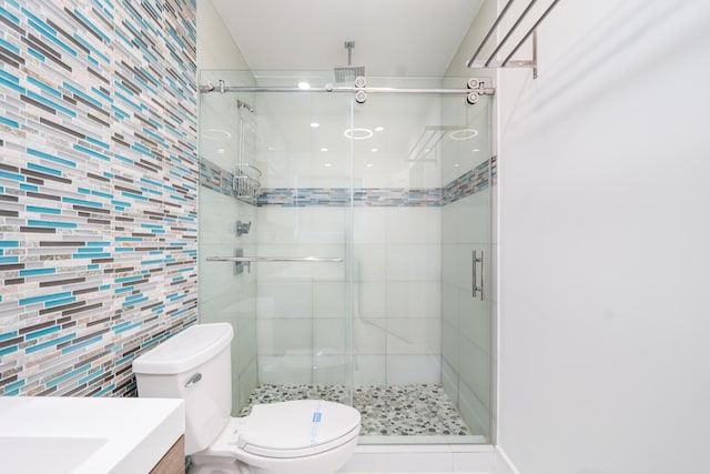 bathroom with tasteful backsplash, an enclosed shower, vanity, tile walls, and toilet