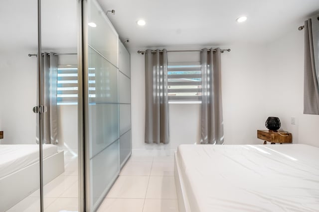 tiled bedroom with a closet