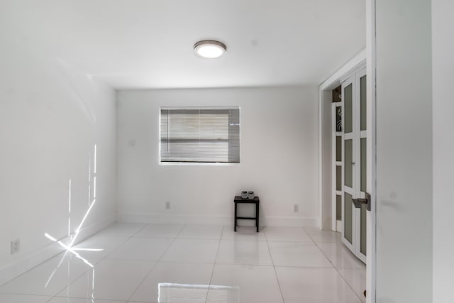 unfurnished room with light tile patterned floors