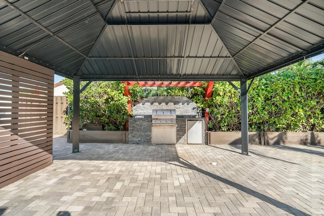 view of patio / terrace featuring a gazebo, area for grilling, and a grill