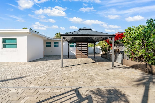 view of patio featuring a gazebo and exterior kitchen