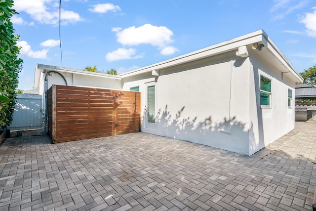 view of side of property with a patio