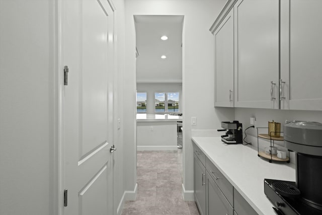 bar featuring baseboards and recessed lighting