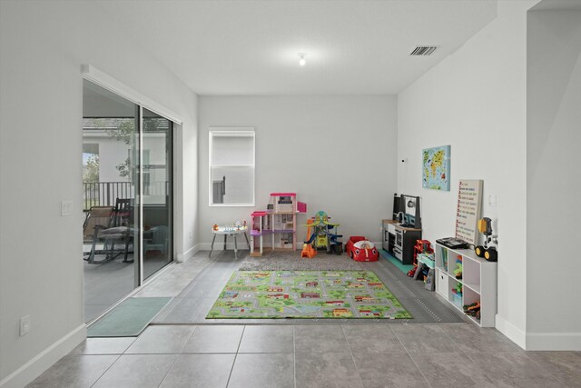 tiled living room with ceiling fan