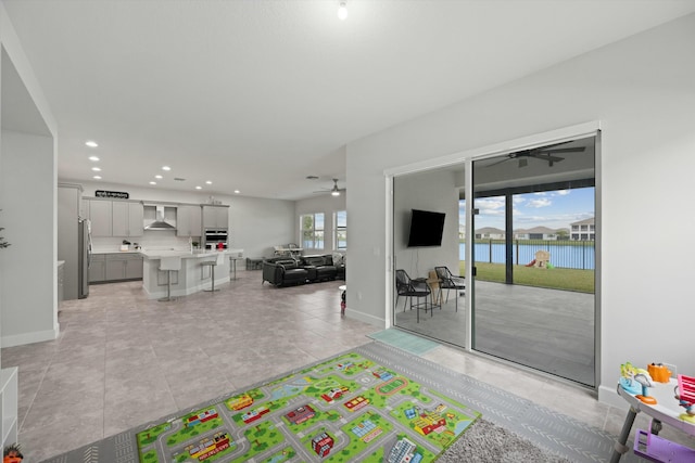 recreation room with light tile patterned floors, baseboards, a ceiling fan, and recessed lighting