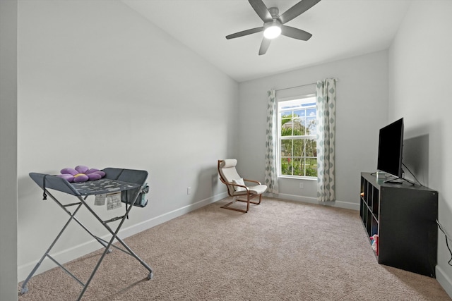 sitting room with carpet, baseboards, vaulted ceiling, and a ceiling fan