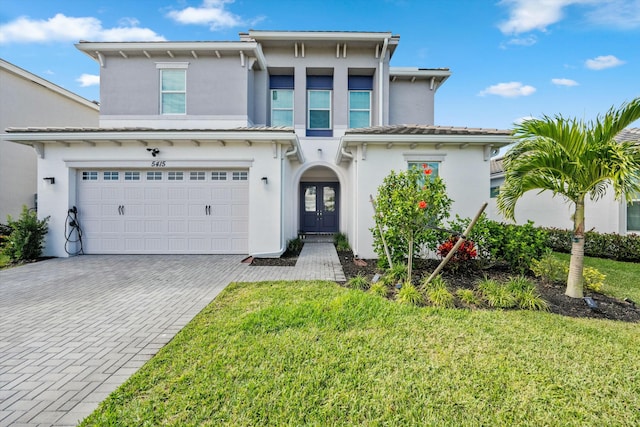 view of front facade with a front yard and a garage