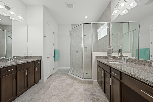 bathroom with vanity, tile patterned floors, and a shower with door