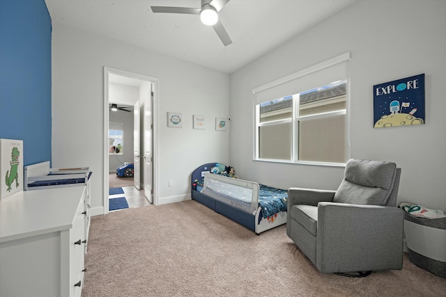 bedroom with light colored carpet, ceiling fan, and baseboards