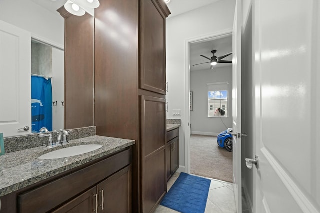 bathroom with ceiling fan, tile patterned flooring, vanity, and baseboards