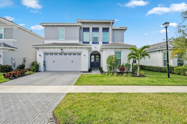 view of front of home featuring a garage and a front lawn