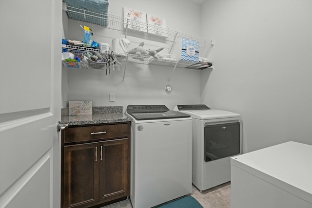 laundry room featuring cabinet space, separate washer and dryer, and light wood-style floors