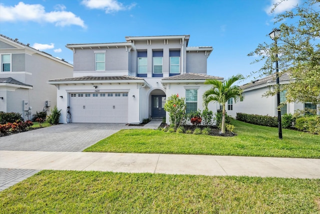 view of front of home with a garage and a front yard